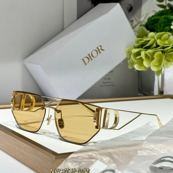 Close-up of Dior 30Montaigne B3U sunglasses highlighting gold CD logo on bold temples and glossy acetate finish