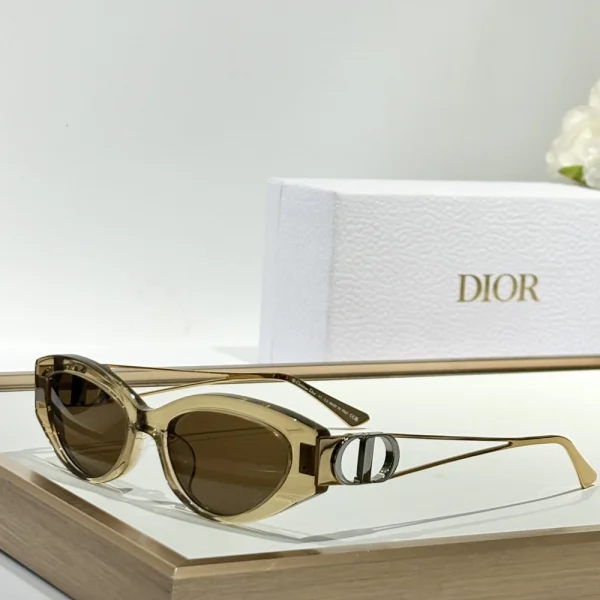 Close-up of Dior 30Montaigne B6F sunglasses highlighting signature gold CD logo on bold temples
