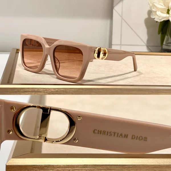 Close-up of Dior 30Montaigne S10F sunglasses highlighting iconic gold CD logo on bold glossy temples
