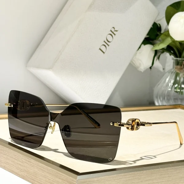 Christian Dior CD Chain M1U sunglasses with bold oversized frame and signature chain detail on temples, styled on white surface