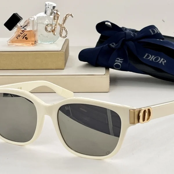Close-up of Dior CD Icon S1F sunglasses highlighting gold CD logo plaque on bold glossy temples