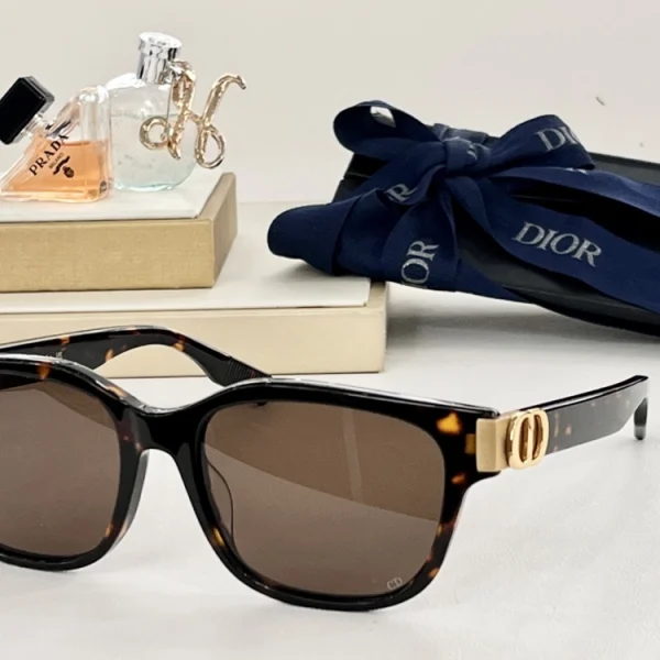 Christian Dior CD Icon S1F sunglasses with oversized square black frame and gradient lenses, styled on a clean white tabletop