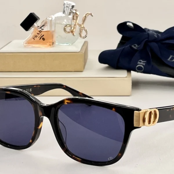 Luxury Dior CD Icon S1F sunglasses placed diagonally on a marble surface under natural daylight
