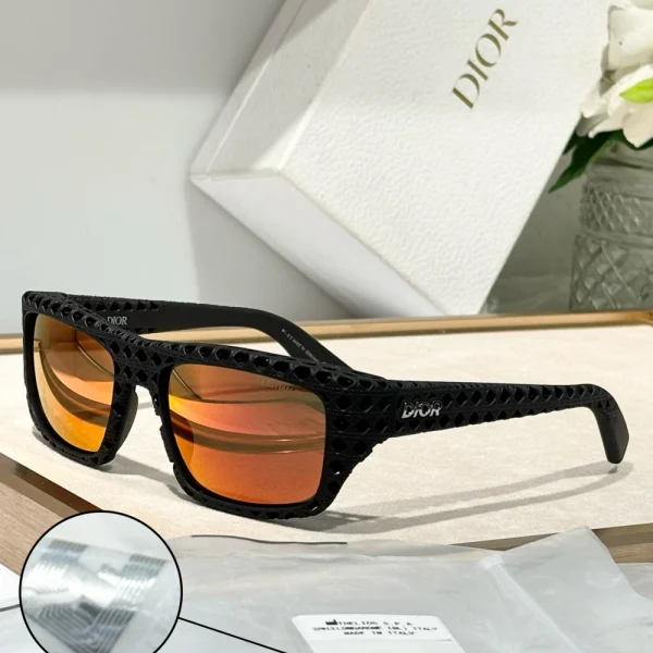 Christian Dior Dior3D S1I sunglasses with futuristic oversized frame in glossy black and dark gradient lenses, styled on a white tabletop
