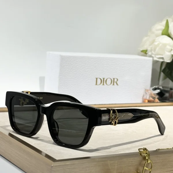 Luxury Dior DiorOblique S1F sunglasses placed diagonally on marble surface under natural lighting