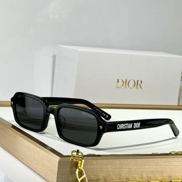 Black Dior DiorPacific S3F sunglasses placed diagonally on marble surface under natural daylight