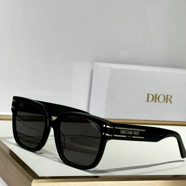 Elegant Christian Dior DiorSignature S7F sunglasses resting beside branded Dior eyewear case and cleaning cloth