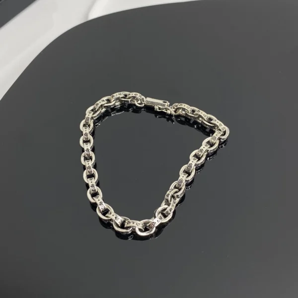 Stylish Chrome Hearts paper chain bracelet crafted in sterling silver with a sleek, modern edge.