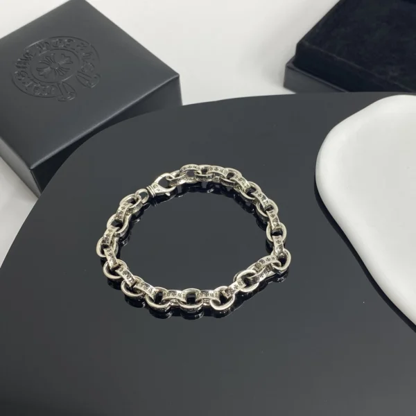 Chrome Hearts paper bracelet in sterling silver featuring flat link chain and signature gothic detailing.