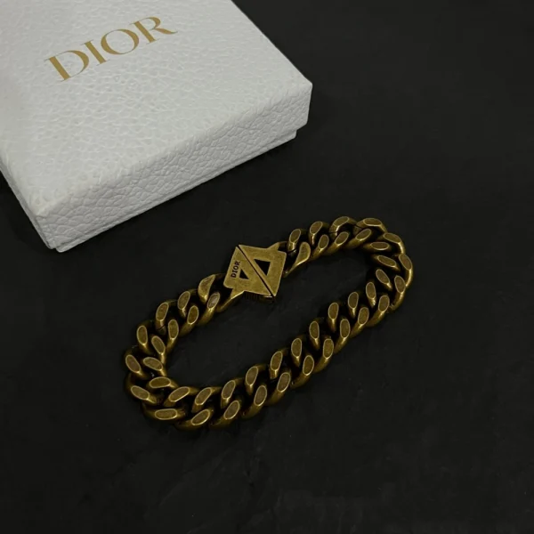 Dior chain bracelet with gold-tone finish and bold CD logo charm