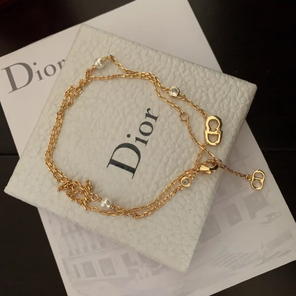 Elegant Dior Clair D Lune necklace showcasing refined curves, delicate chain, and signature crystal-embellished charm.