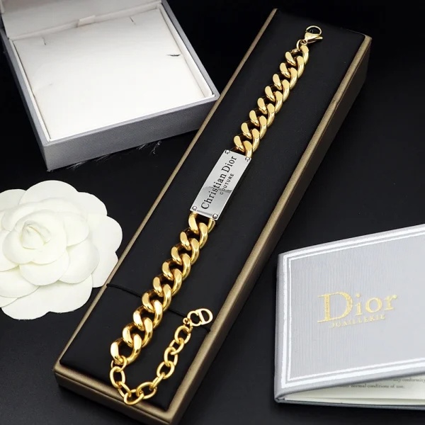 Stylish Dior Couture gold bracelet worn with luxury fashion