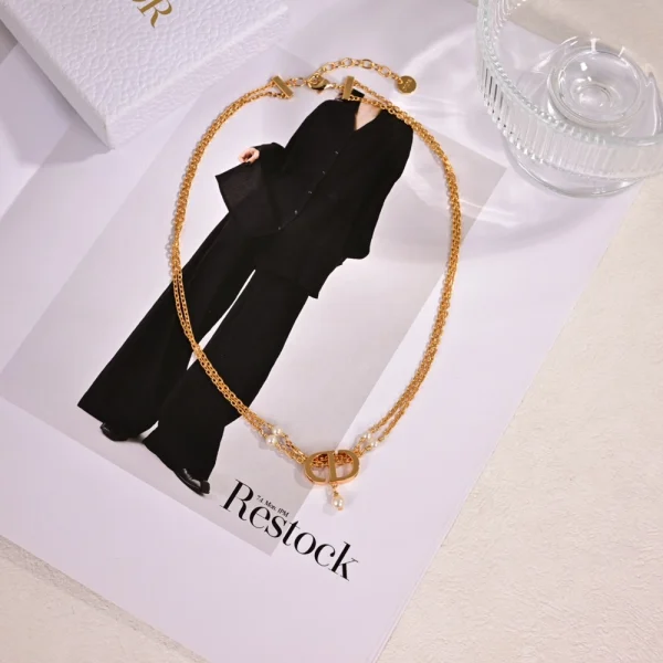 Dior gold necklace with pearl accents and signature CD charm