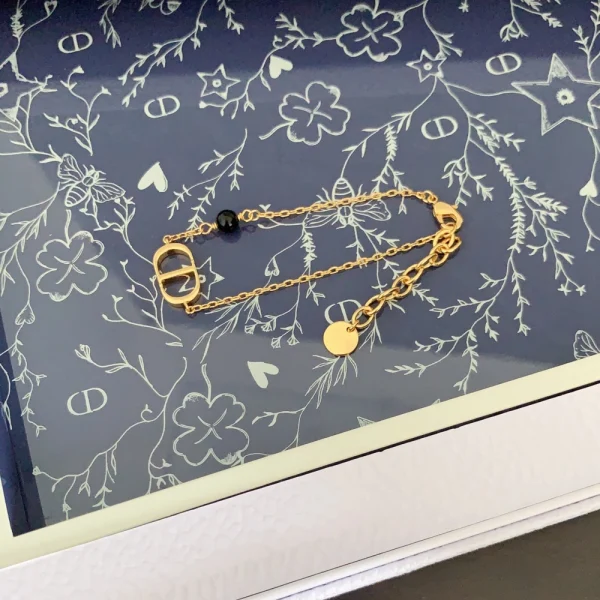 Close-up of Dior Petit CD bracelet featuring gold-tone finish and fine craftsmanship