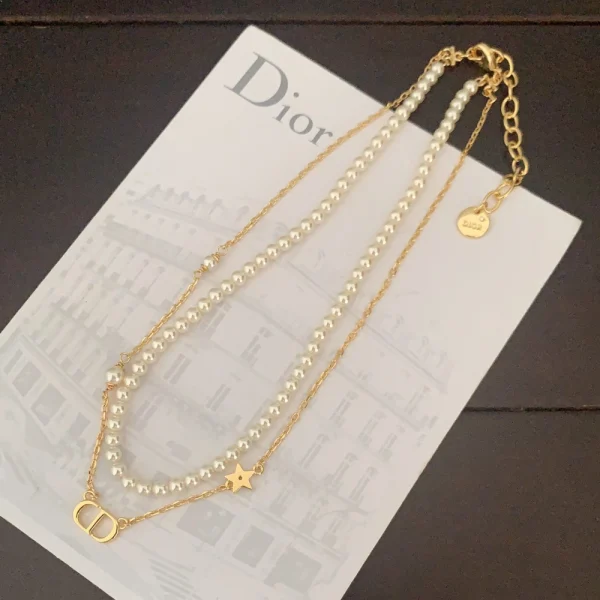 Dior Petit necklace featuring a delicate chain and minimalist CD charm in gold-tone metal.