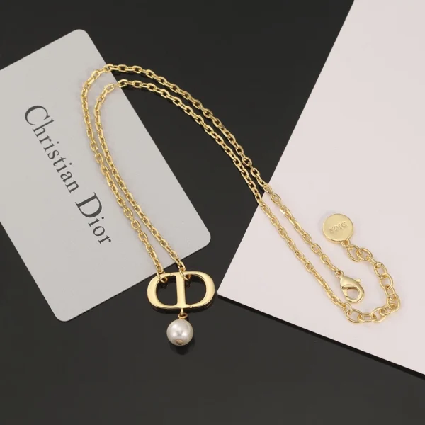 Dior Petit CD necklace design featuring the iconic CD initials with minimalist elegance in gold-tone metal.