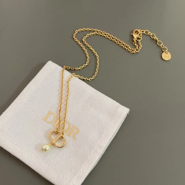 Close-up of Dior Petit CD necklace showcasing refined craftsmanship, delicate chain, and signature logo charm.