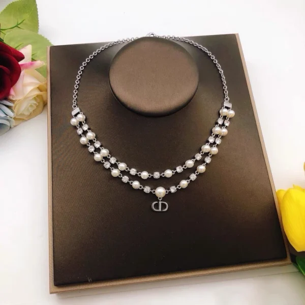 Dior Petit CD Treasure necklace featuring gold-tone metal with a delicate chain and CD charm adorned with crystals.