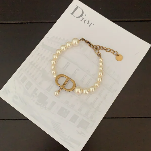 Dior bracelet with white resin pearls and gold-tone CD charm