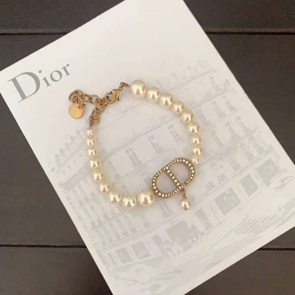 Elegant Dior bracelet featuring white pearls and signature logo accent