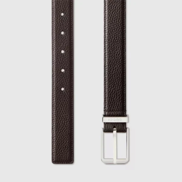Detailed close-up of Gucci leather belt highlighting the sleek rectangular buckle and smooth finish