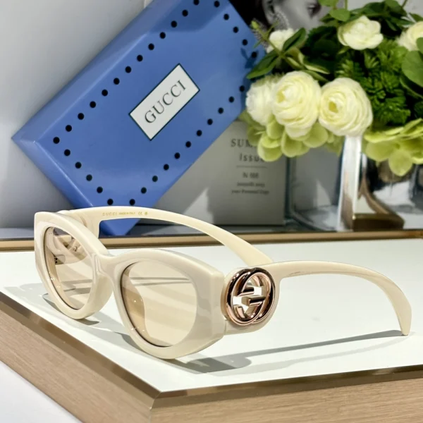 Gucci cat-eye frame sunglasses with bold winged design and signature logo on temples