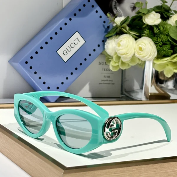 Close-up of Gucci cat-eye sunglasses showcasing feminine silhouette and gold-tone branding