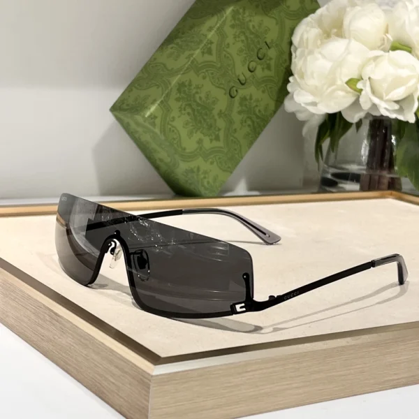 Gucci mask sunglasses photographed in natural light, emphasizing curved lines and luxury detailing