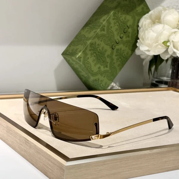 Gucci designer sunglasses with mask-inspired frame, modern silhouette and streetwear appeal