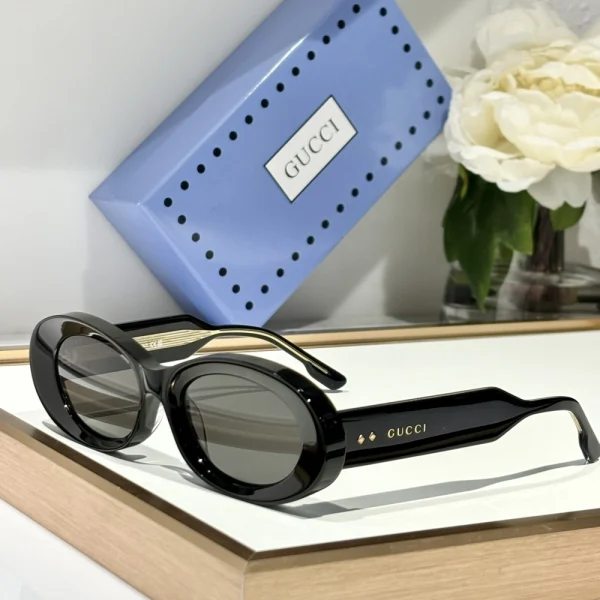 Gucci oval-frame sunglasses with slim temples and vintage-inspired silhouette