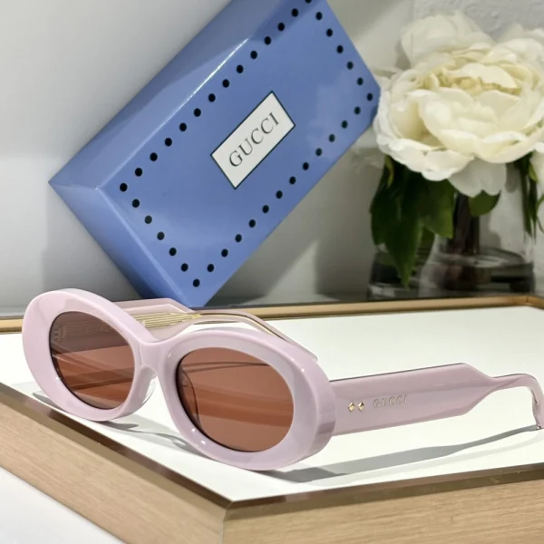 Gucci oval sunglasses with high-quality acetate frame and lightly tinted lenses