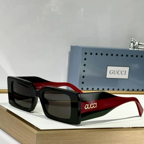 Elegant Gucci rectangular sunglasses placed on white background, highlighting clean lines and premium finish