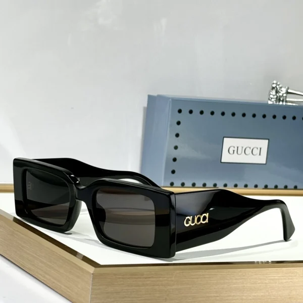 Gucci sunglasses featuring sharp rectangular frame, tinted lenses, and signature Italian craftsmanship