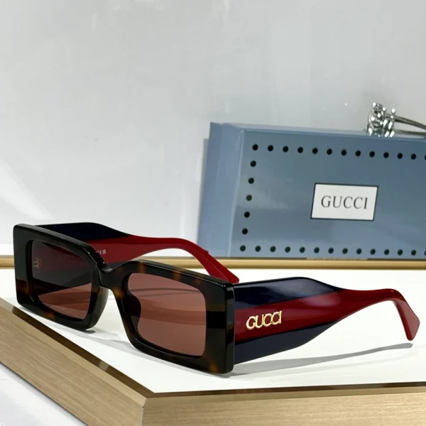 Model wearing Gucci rectangular-frame sunglasses – minimal, sophisticated, and fashion-forward