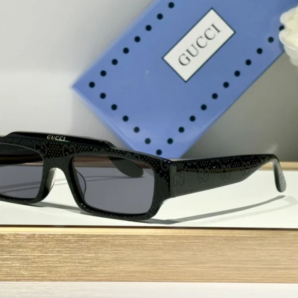 Black Gucci rectangular sunglasses with high-gloss acetate and clean lens cut