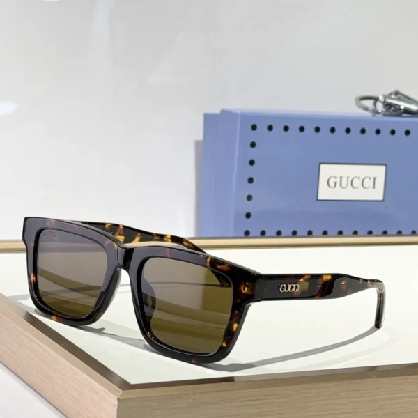 Flat lay of Gucci rectangular sunglasses with hard case and microfiber cloth, perfect for everyday use