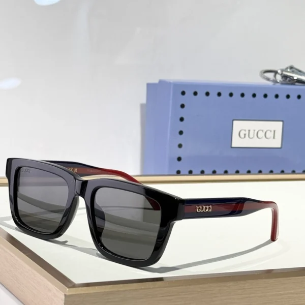 Branded Gucci rectangular-frame sunglasses next to original packaging, exuding premium presentation