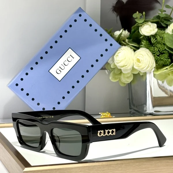 Close-up of Gucci GG-SG56 sunglasses showcasing minimalist rectangular shape and signature temple logo