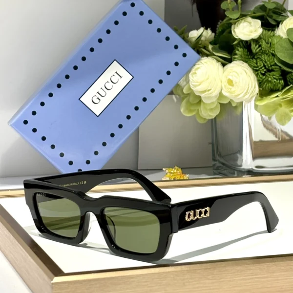 Gucci rectangular sunglasses GG-SG55 resting on white tabletop, paired with branded case in background