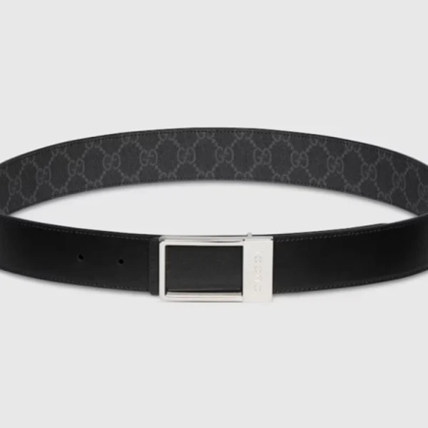 Close-up of Gucci Reversible Black GG Supreme Belt highlighting polished rectangular buckle and fine craftsmanship
