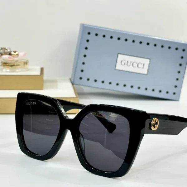 Gucci Square-frame sunglasses resting on white surface, highlighting sharp edges and luxury finish