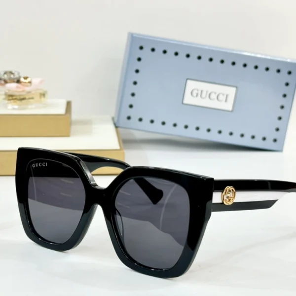 Elegant Gucci sunglasses with bold square frame, captured under soft lighting for premium look