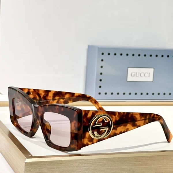 Model wearing Gucci square-frame sunglasses – timeless luxury with modern edge