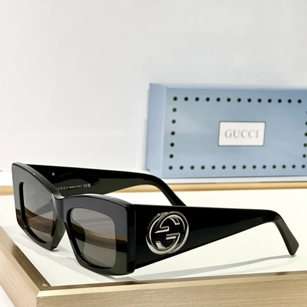 Black Gucci square sunglasses with thick acetate frame and elegant gold-tone branding