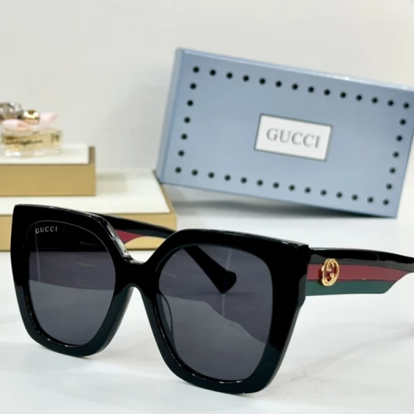 Black Gucci Square-frame sunglasses with dark lenses and gold logo detail at temples