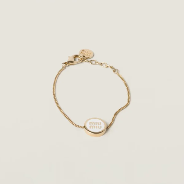 Close-up of Miu Miu bracelet with polished metal base and colorful enamel coating