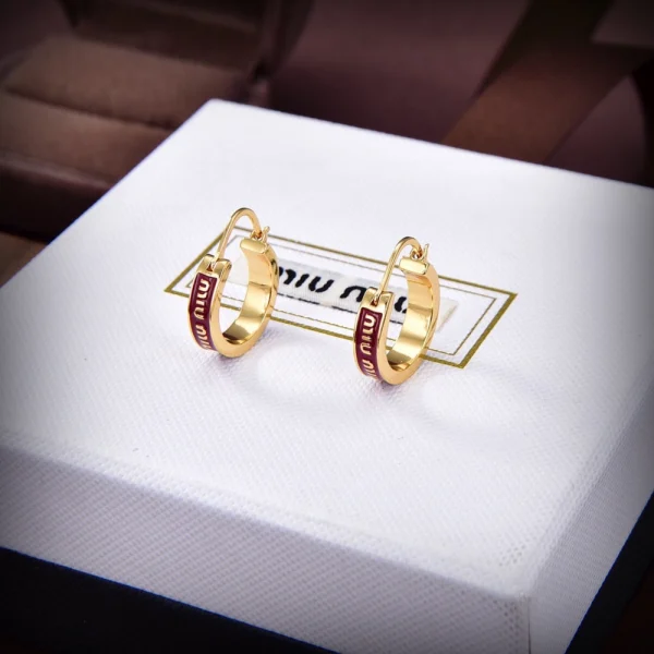 Miu Miu enameled metal earrings in vibrant red with glossy finish and modern design