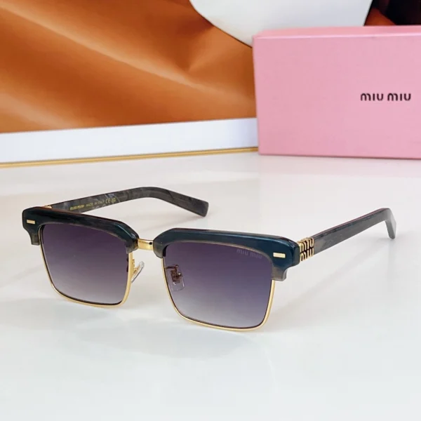 Close-up of Miu Miu browline sunglasses showcasing sleek acetate brow bar, slim metal frame, and embossed logo on the temple