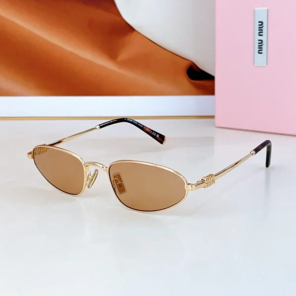 Trendy oval sunglasses by Miu Miu featuring retro-inspired shape and signature logo accent