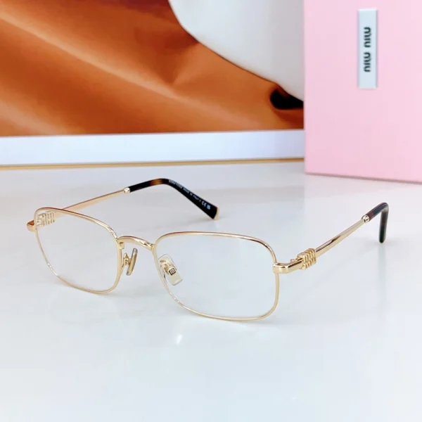 Miu Miu MM-SG70 sunglasses resting on marble, showcasing chic fashion aesthetic